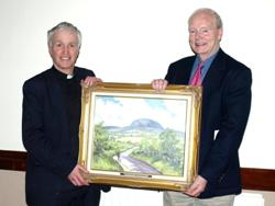 Chancellor Stuart  Lloyd  presents Mr Harry Fisher with a painting of Slemish in appreciation for his 33 years service as  Hon. Secretary to the Parish of Kilconriola and Ballyclug.    